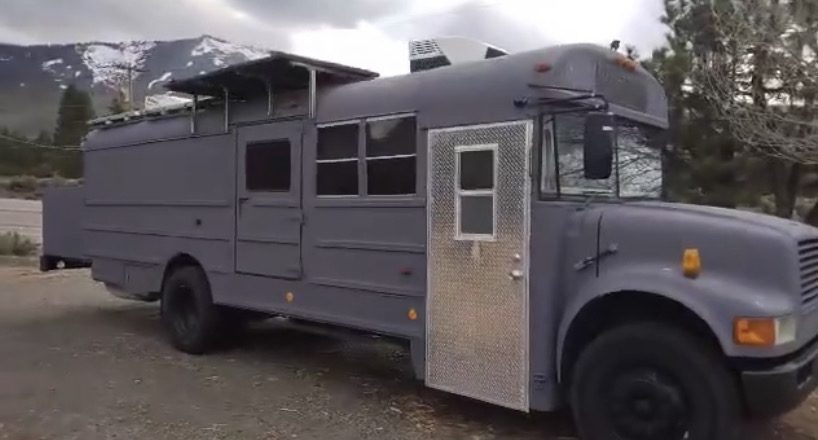 The Beast — front angle with diamond-plate door and rooftop solar