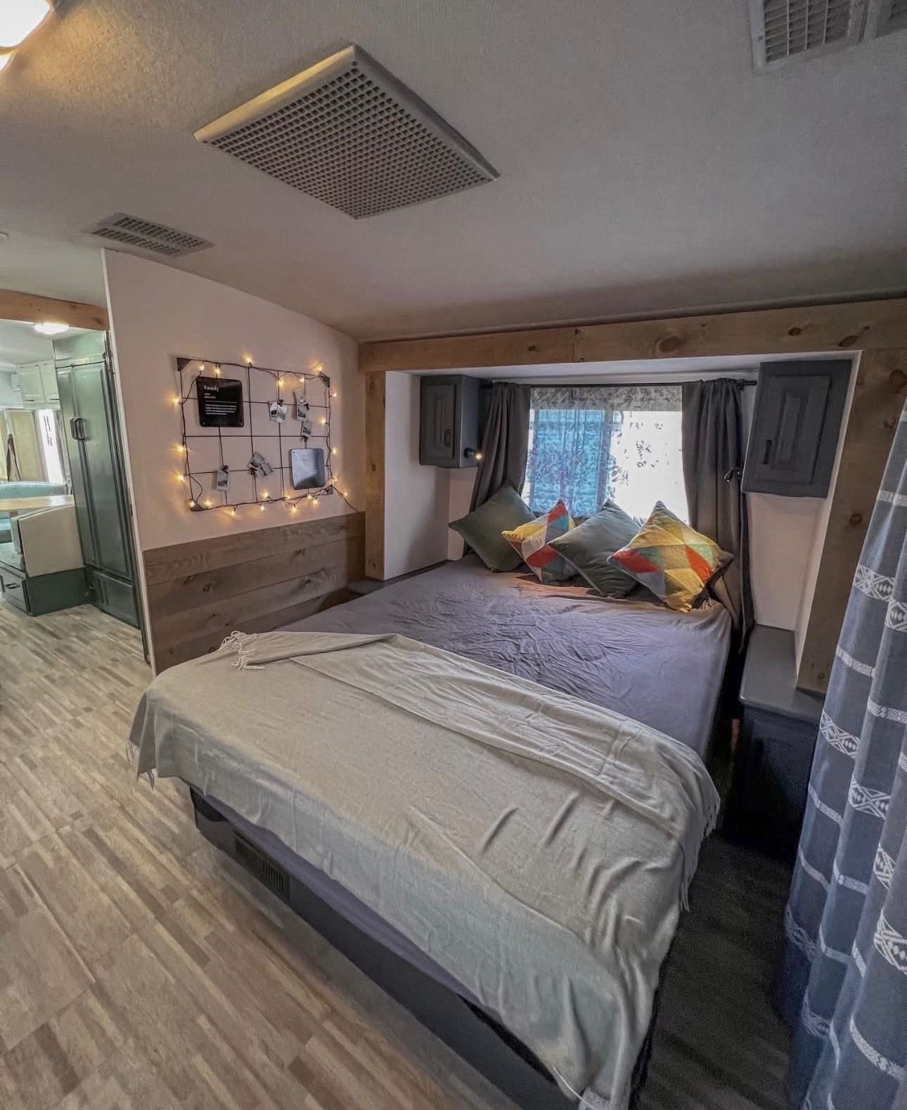 Pinkford RV interior — bedroom with fairy lights