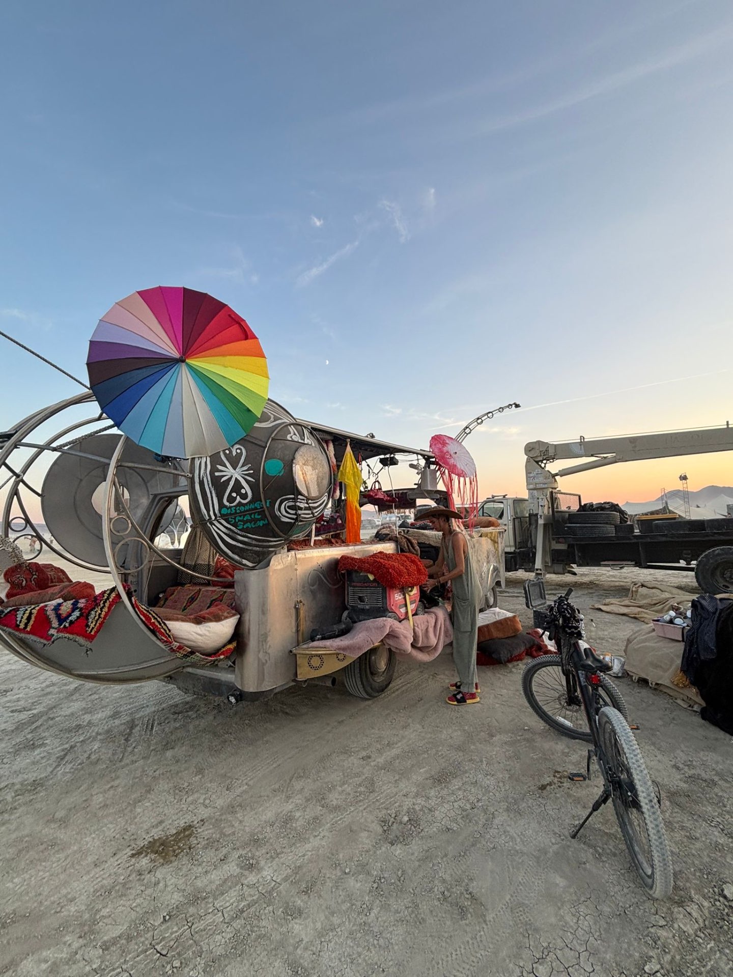 Snail Disconnect Salon at sunset with rainbow umbrella